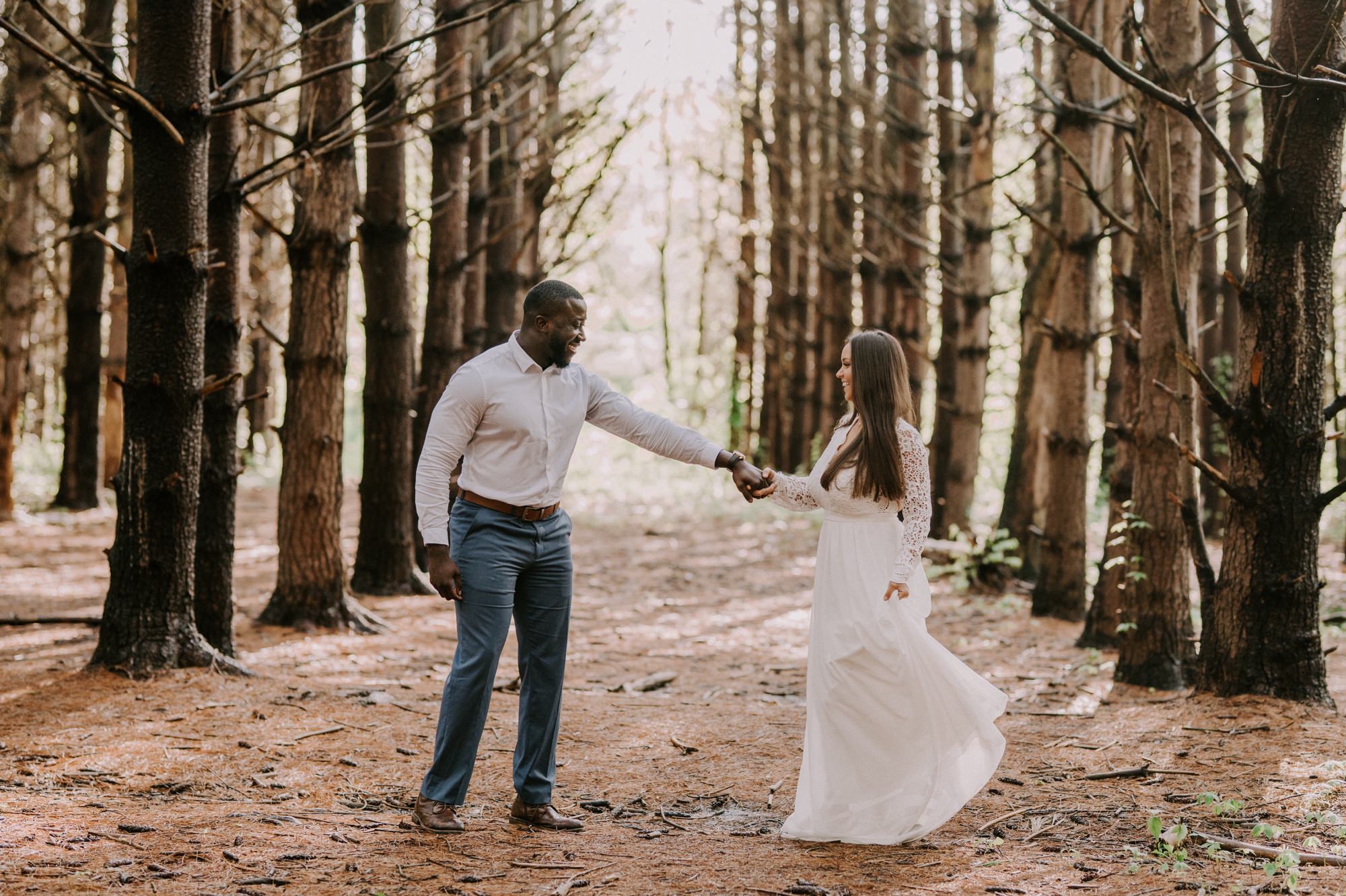  Man spinning fiance in burr oak woods engagement session 