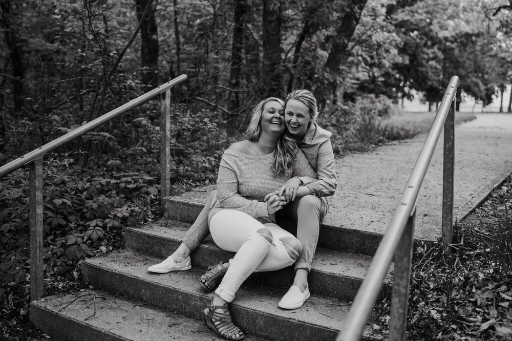 Two women laughing on steps in Clinton Lake