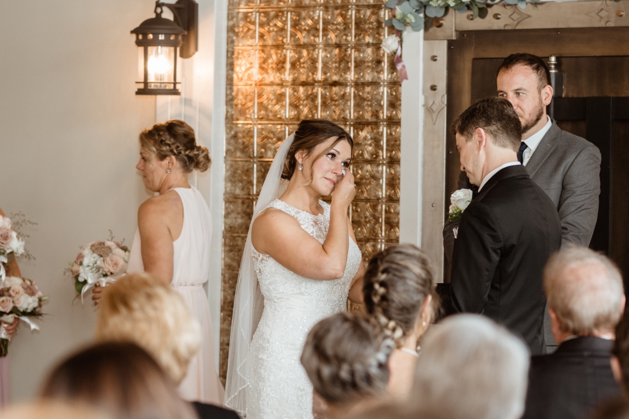 bride wipes away her tears during 8th and main wedding ceremony