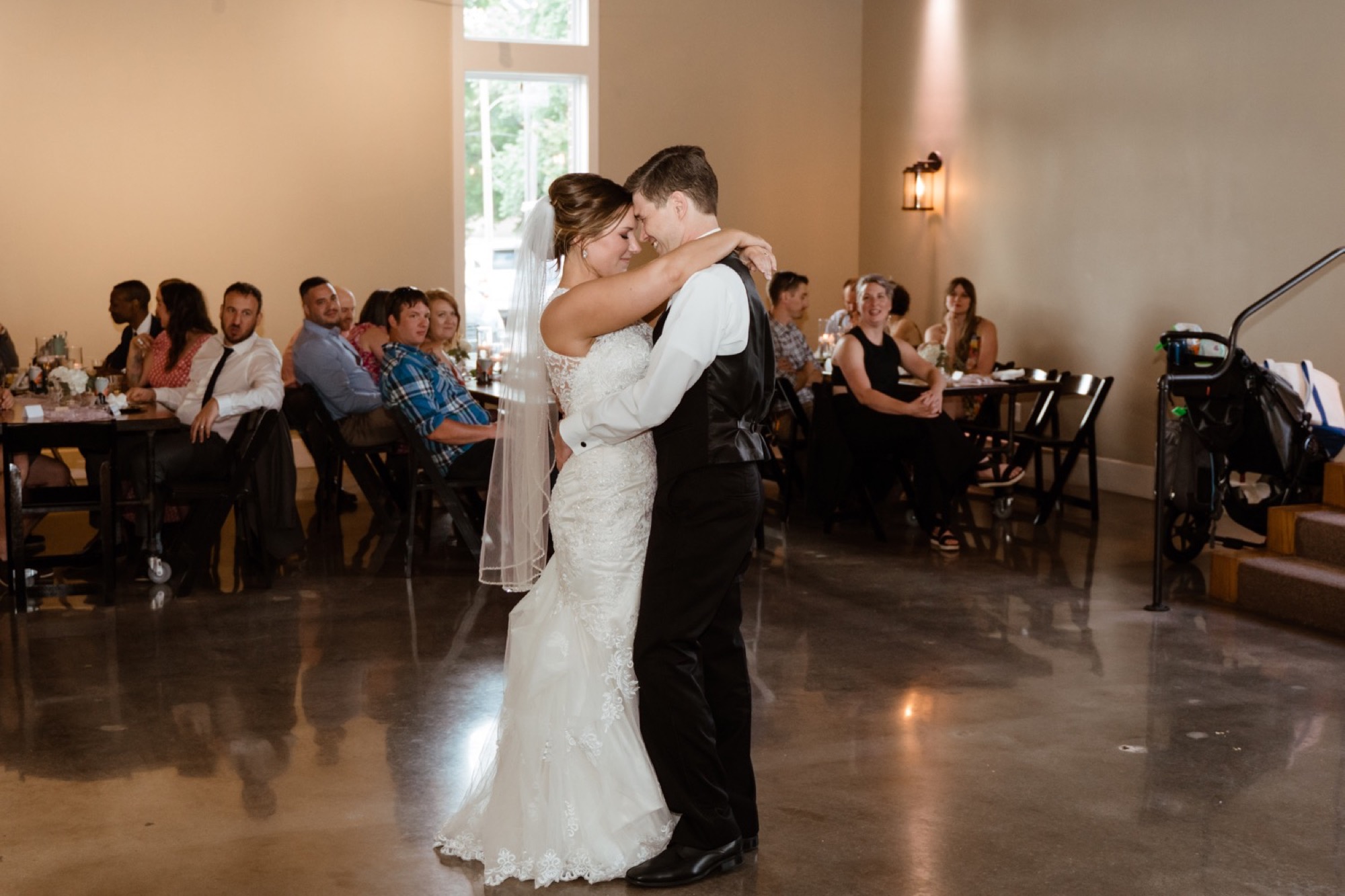 the bride and groom share a first dance during their 8th and main wedding
