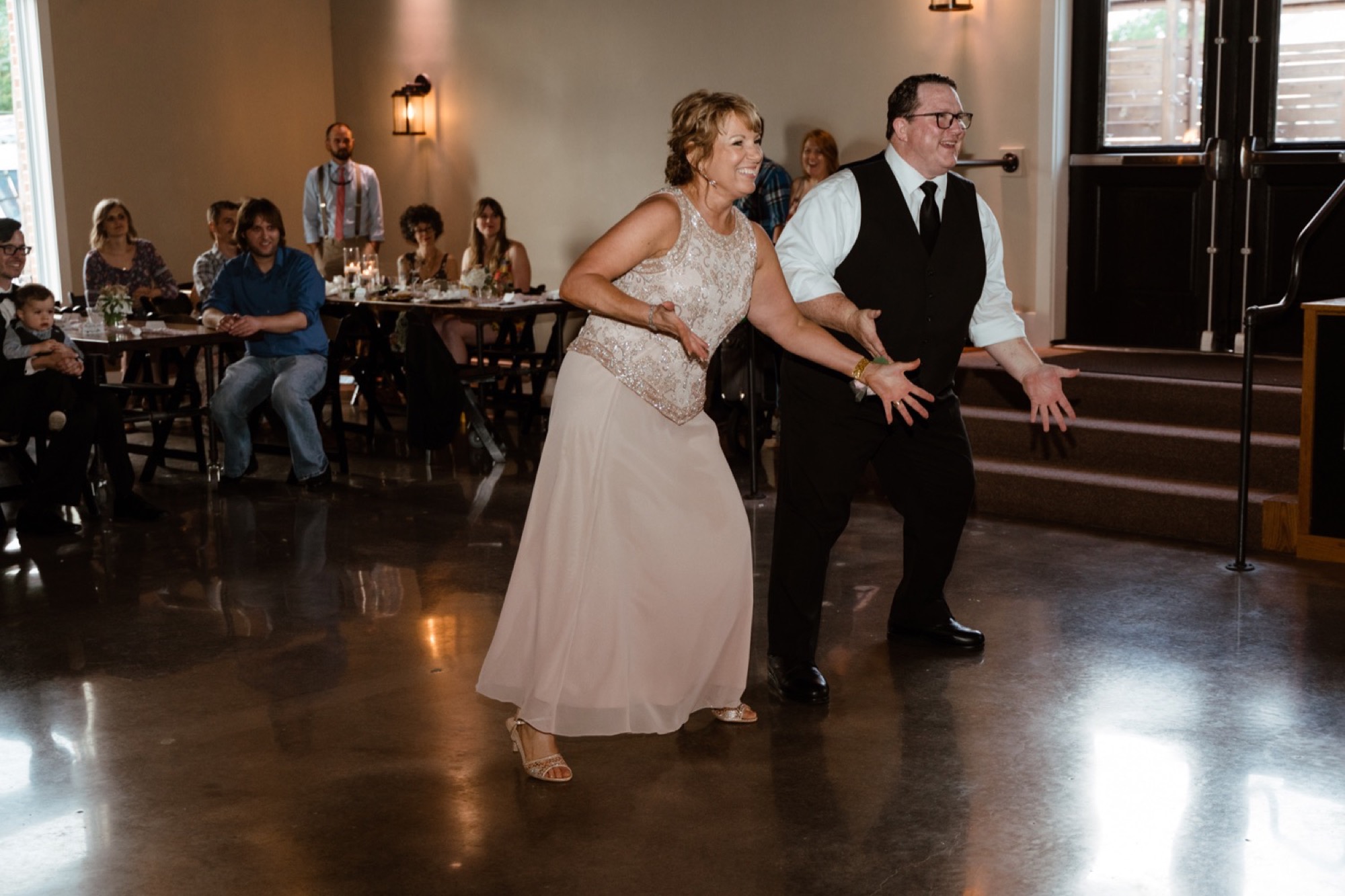 mother and father of groom perform dance during 8th and main wedding