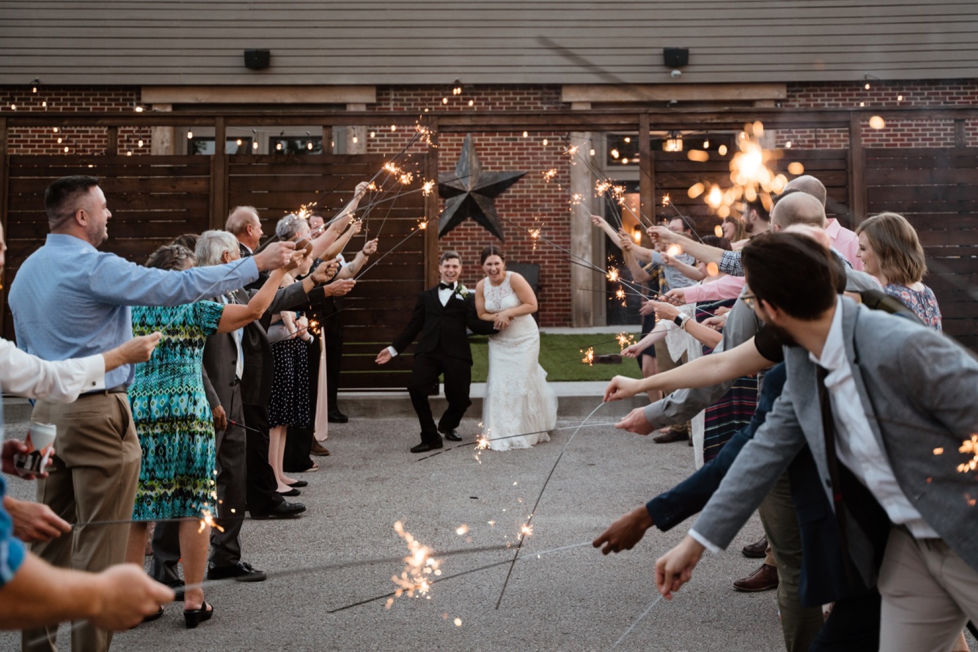 bride and groom sparkler exit outside of 8th and main wedding