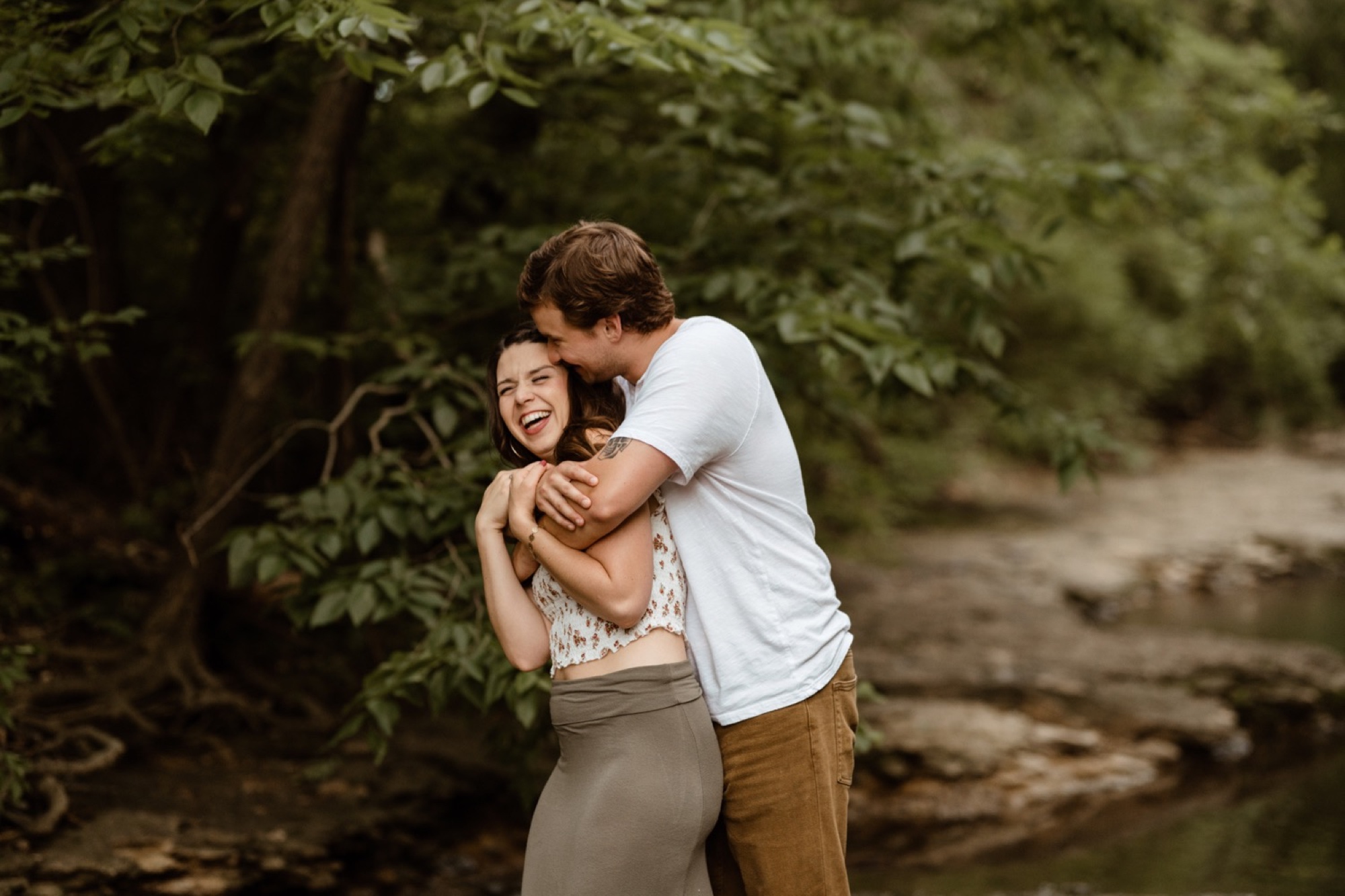couple hugs and kisses during winterset engagement session