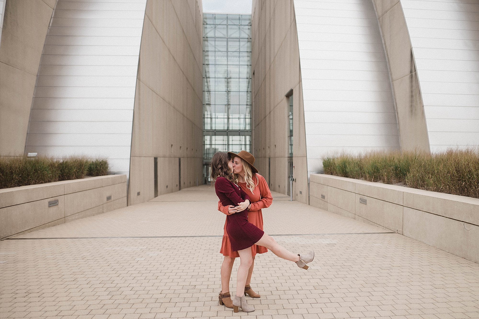 Woman dipping her fiance during kauffman center engagement
