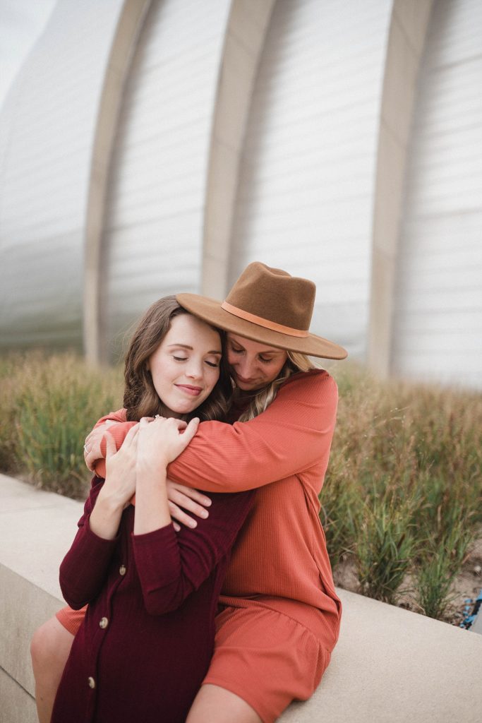 couple cuddles into each other during kauffman center engagement