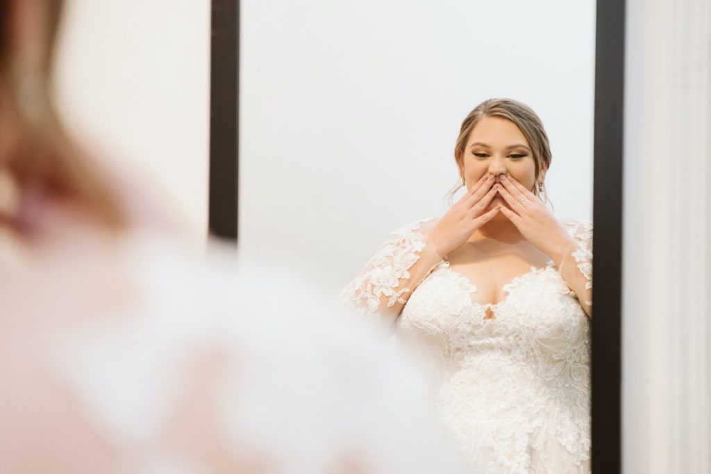 bride seeing herself in the mirror at uptown theater wedding