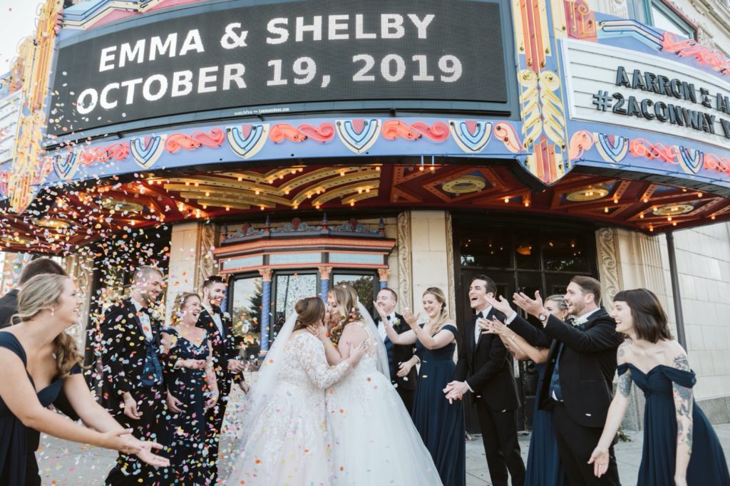 kissing in biodegradable confetti at uptown theater wedding