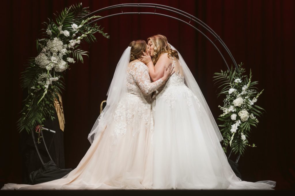 brides first kiss during uptown theater wedding