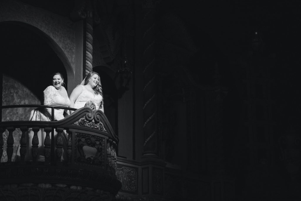 brides on juliet balcony at uptown theater wedding