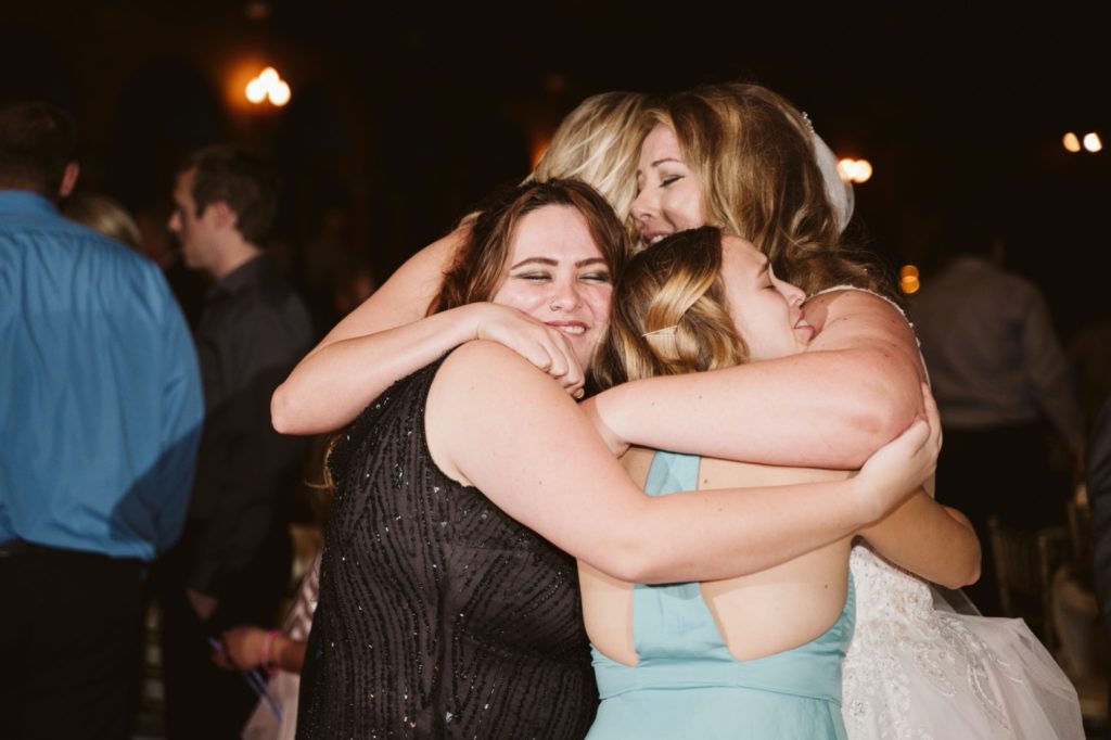 bride hugging friends at uptown theater wedding