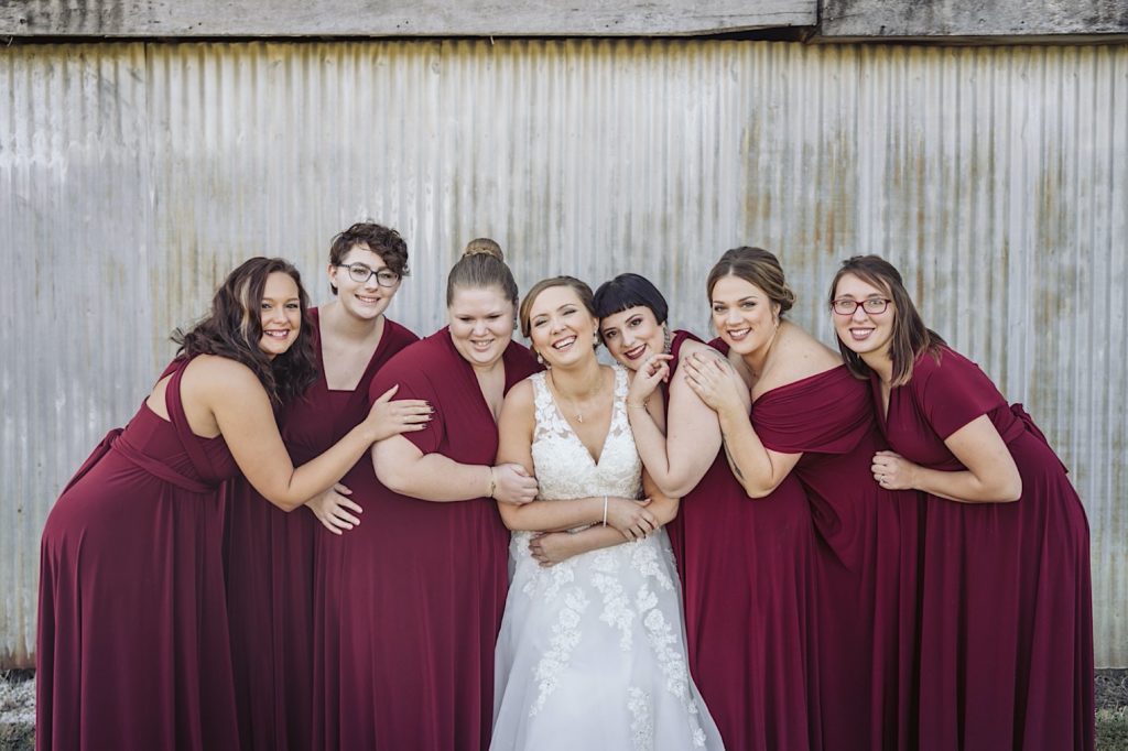 bridesmaids hug together at sweet clover farms wedding
