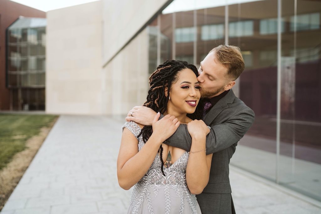 couple hugs during elegant nerman museum engagement 