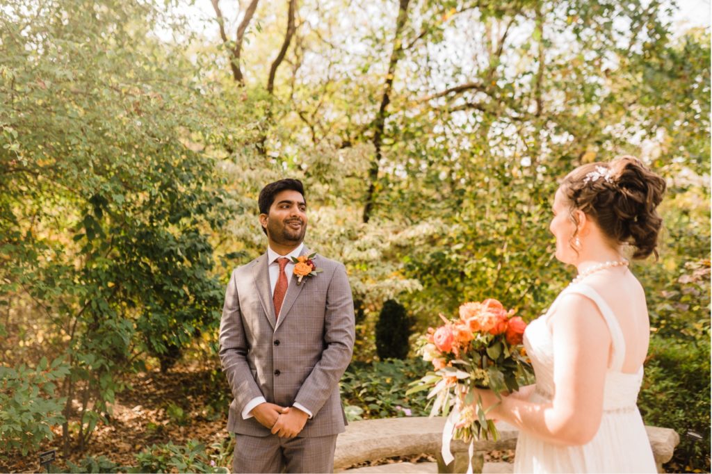 groom sees bride for the first time at overland park arboretum wedding