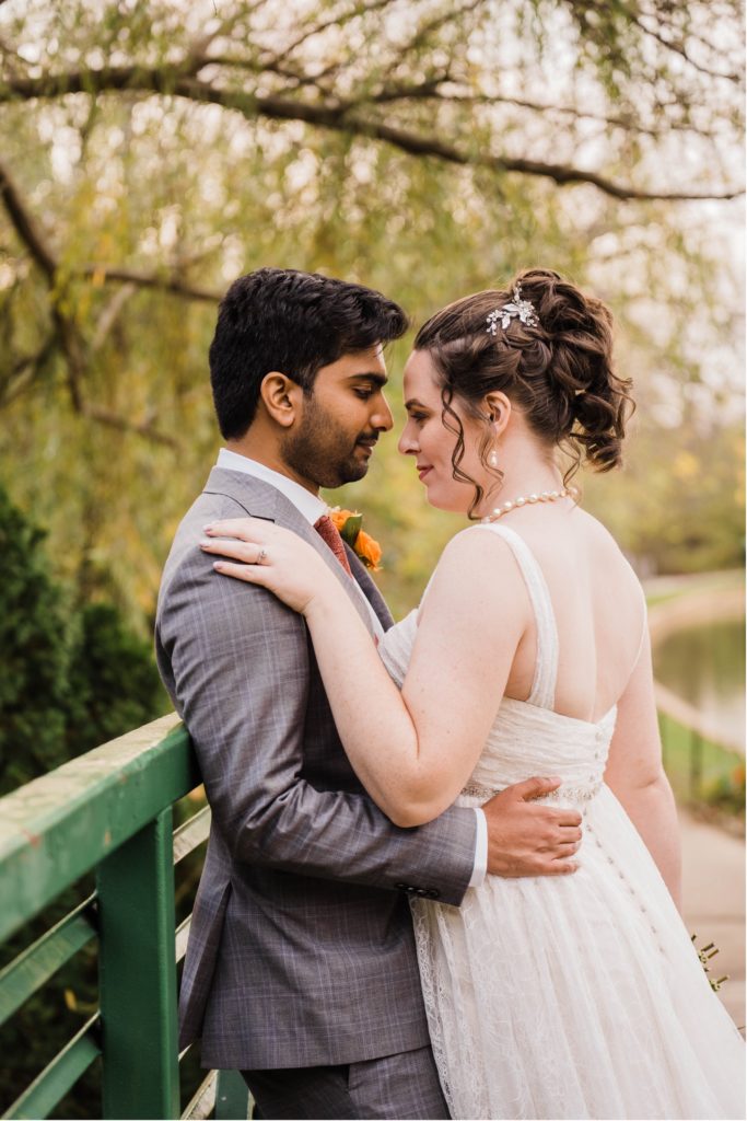 couple on monet bridge at overland park arboretum wedding