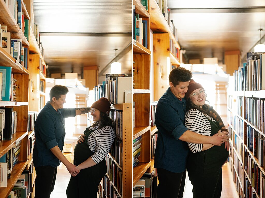 pregnant couple stand against book stacks at prospero's books
